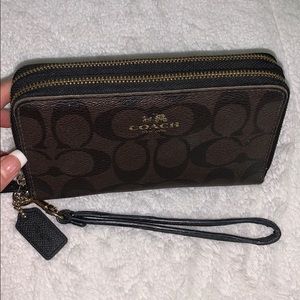 brown and black leather COACH wristlet/wallet